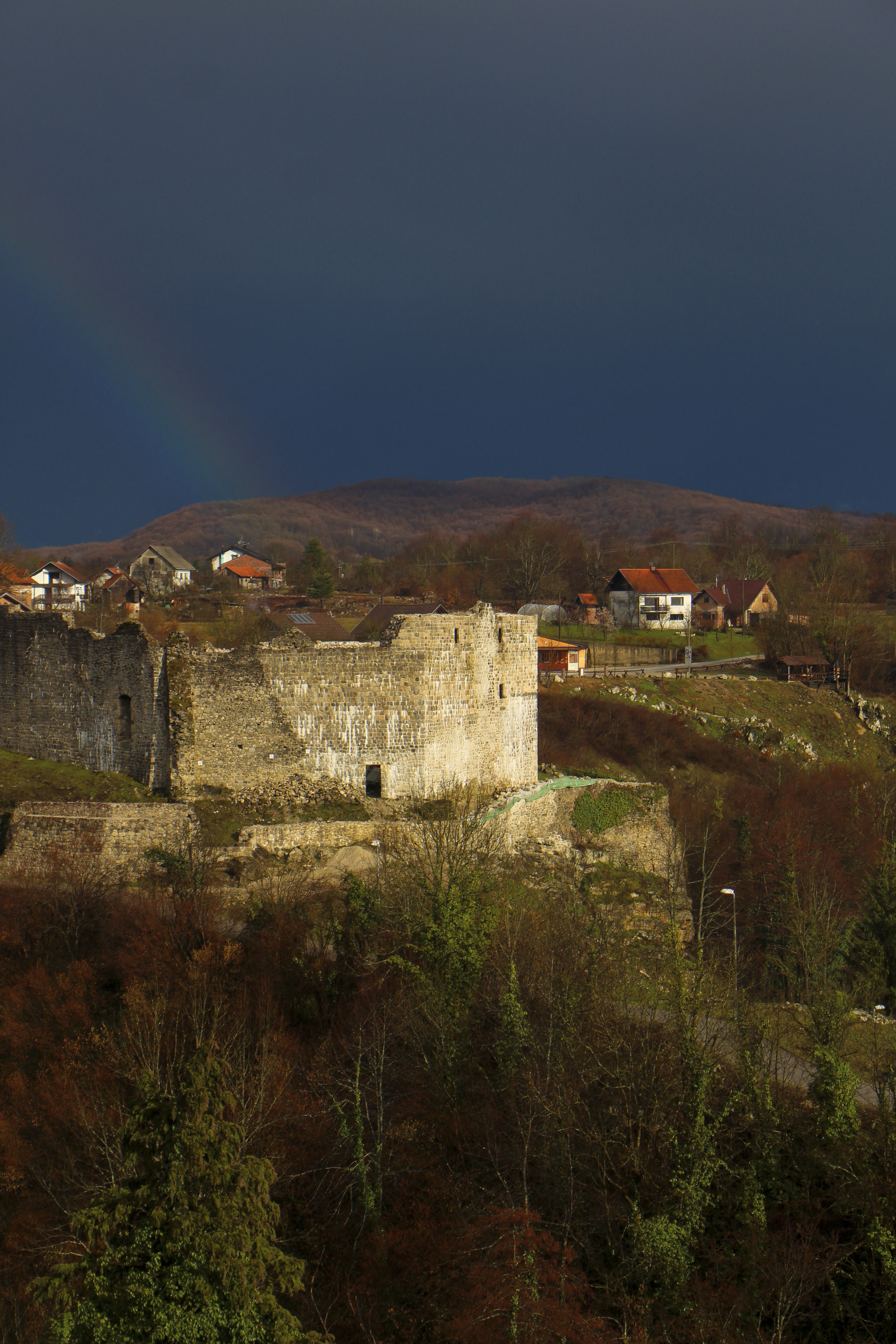 rainbow over fort ruins in rastoke croatia